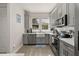 Well-lit kitchen featuring stainless steel appliances and white countertops at 14203 Avenue Of The Grvs, Winter Garden, FL 34787