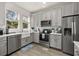 Bright kitchen featuring stainless steel appliances, ample cabinets, and a farmhouse sink at 14203 Avenue Of The Grvs, Winter Garden, FL 34787