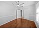 Bedroom with wood floors, a ceiling fan, and an arched doorway at 1536 Softshell St, St Cloud, FL 34771