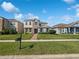 Charming two-story home with stone accents, blue shutters, landscaped yard, and brick walkway at 1536 Softshell St, St Cloud, FL 34771