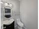 Well-lit half bathroom features a pedestal sink, modern lighting, and a coordinated mirror with sleek fixtures at 1536 Softshell St, St Cloud, FL 34771