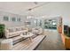 Bright living room with neutral decor, modern lighting, and sliding glass doors to the screened patio at 1536 Softshell St, St Cloud, FL 34771