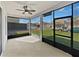 Enclosed sun room with screens and black frames and a ceiling fan at 1536 Softshell St, St Cloud, FL 34771