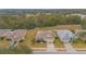 Aerial view of a residential neighborhood, highlighting a home with manicured landscaping at 1660 Mountclair Ct, Mount Dora, FL 32757