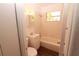 Clean bathroom featuring a single vanity, updated tile, a window, and a shower-tub combo at 1801 Riley Ave, Orlando, FL 32805