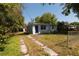 Charming single-story home features a blue front door and well-maintained landscaping at 1801 Riley Ave, Orlando, FL 32805