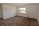 Living Room featuring carpet flooring, natural light, and a white entry door at 1801 Riley Ave, Orlando, FL 32805