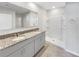 Bathroom featuring double sinks, granite countertops, and a walk-in shower at 1925 Arbor Mill Ln, Kissimmee, FL 34744