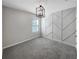 Stylish bedroom with a modern light fixture and unique geometric accent wall at 1925 Arbor Mill Ln, Kissimmee, FL 34744