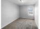 Cozy bedroom featuring neutral carpet and a window offering plenty of natural light at 2033 Milkweed St, Ocoee, FL 34761