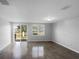 Bright living room with tile flooring, sliding glass door to backyard and large windows at 2033 Milkweed St, Ocoee, FL 34761