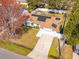 Aerial view of the house and yard featuring solar panels on the roof at 211 Dalton Dr, Kissimmee, FL 34758