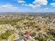 An aerial view shows the single-Gathering home in a vibrant community with well-maintained streets, and many mature trees at 211 Dalton Dr, Kissimmee, FL 34758