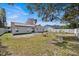 Large backyard featuring a new fence and solar panels at 211 Dalton Dr, Kissimmee, FL 34758