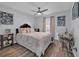 Cozy bedroom with ceiling fan, decorative artwork and a comfortable bed with accent pillows at 211 Dalton Dr, Kissimmee, FL 34758