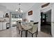 Elegant dining room featuring stylish chairs, chandelier, and a view to the bedroom at 211 Dalton Dr, Kissimmee, FL 34758