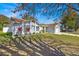 View of the house from the side showcasing the front yard and a partial view of the driveway at 211 Dalton Dr, Kissimmee, FL 34758