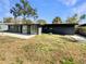 Exterior view of a home with a spacious backyard and mature trees under a clear sky at 214 Cherrywood Dr, Maitland, FL 32751