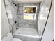 Modern bathroom featuring a large bathtub, marble-look tile, and a bright window at 214 Cherrywood Dr, Maitland, FL 32751