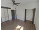 Bedroom with modern closet doors, neutral walls, and wood-look flooring at 214 Cherrywood Dr, Maitland, FL 32751