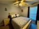 Comfortable bedroom with ceiling fan, window and natural light at 229 Silverton Rd, Davenport, FL 33897