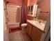 Cozy bathroom featuring a shower-tub combo, vanity, medicine cabinet, and decorative accents at 2450 Southern Oak St, The Villages, FL 32162