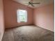 Empty bedroom featuring neutral carpeting, a ceiling fan, and natural light at 2450 Southern Oak St, The Villages, FL 32162