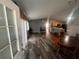 Inviting living room featuring wood-like flooring, neutral paint, and a ceiling fan at 2450 Southern Oak St, The Villages, FL 32162