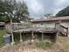 Exterior view of a weathered wooden deck, showing wear and potential for renovation at 2626 Balkan St, Apopka, FL 32703