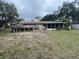 Backyard view with a deck, screened porch, and grassy area, offering outdoor living space at 2626 Balkan St, Apopka, FL 32703