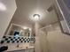 Cozy bathroom with a shower, sink, mirror and an exhaust fan at 2626 Balkan St, Apopka, FL 32703