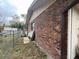 Photo displays the brick wall and exterior of the home's back, showcasing sturdy construction and architectural detail at 2626 Balkan St, Apopka, FL 32703