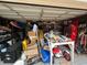 Cluttered garage space with tools, boxes, and household items at 2626 Balkan St, Apopka, FL 32703