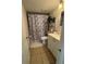 Bathroom with white vanity, toilet, and shower with curtain at 2761 L B Mcleod Rd # A, Orlando, FL 32805