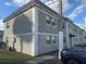 Two-story apartment building with gray stucco and white trim on a sunny day at 2761 L B Mcleod Rd # A, Orlando, FL 32805