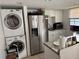 Compact kitchen with stainless steel appliances and stacked washer dryer at 2761 L B Mcleod Rd # A, Orlando, FL 32805