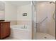 Inviting bathroom features soaking tub, walk-in shower, and neutral tile at 2801 S Ridgewood Ave # 1412, South Daytona, FL 32119