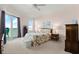 Light-filled main bedroom featuring a walk-out to the balcony, plush carpet, and coastal decor at 2801 S Ridgewood Ave # 1412, South Daytona, FL 32119