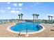 Resort-style swimming pool with chairs and umbrellas at 2801 S Ridgewood Ave # 1412, South Daytona, FL 32119