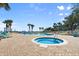 Resort-style pool and jacuzzi surrounded by palm trees and lounge chairs at 2801 S Ridgewood Ave # 1412, South Daytona, FL 32119