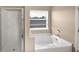 Bathroom featuring a combination shower and tub, with a view from the window at 2840 Grasmere View Pkwy, Kissimmee, FL 34746