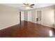 Spacious bedroom featuring a ceiling fan, wood floors, and multiple closets and doorways at 2840 Grasmere View Pkwy, Kissimmee, FL 34746