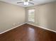 Bedroom with wood floors, a ceiling fan, and natural light from a window at 2840 Grasmere View Pkwy, Kissimmee, FL 34746