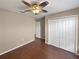 Bedroom featuring wood floors, a decorative ceiling fan, and a closet at 2840 Grasmere View Pkwy, Kissimmee, FL 34746