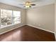 Bedroom with beautiful wood floors, a ceiling fan, and a window at 2840 Grasmere View Pkwy, Kissimmee, FL 34746