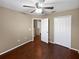 Bedroom with wood floors, a ceiling fan, closet, and a doorway at 2840 Grasmere View Pkwy, Kissimmee, FL 34746