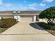 Double car garage with a driveway and well-maintained landscaping at 2840 Grasmere View Pkwy, Kissimmee, FL 34746