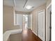 Upstairs hallway with hardwood floors, neutral walls, and doorways at 2840 Grasmere View Pkwy, Kissimmee, FL 34746