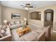 Inviting living room featuring neutral walls, plush carpeting, ceiling fan, and comfortable seating arrangement at 2840 Grasmere View Pkwy, Kissimmee, FL 34746