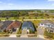 Aerial view of three homes with manicured lawns in a suburban neighborhood at 2993 Irish Peach Dr, Winter Garden, FL 34787